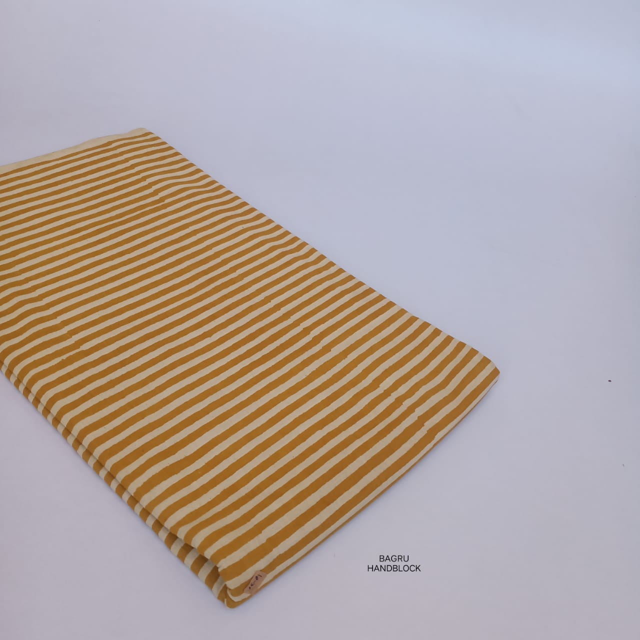 Mustard striped Bagru handblock print fabric in pure cotton, artisan-crafted and perfect for contemporary ethnic wear.